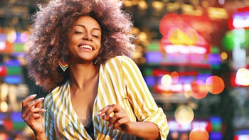 dopamine agonist: happy person dancing at concert 1012989218