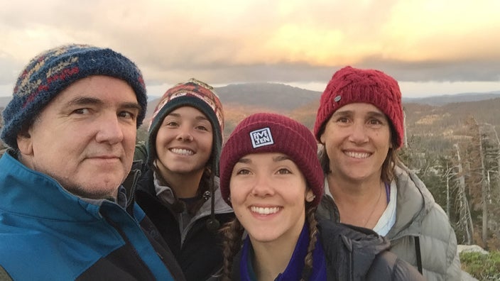  Rebecca and her family taking a selfie on a hike. Her husband on the left and twin teenage daughters in the middle.