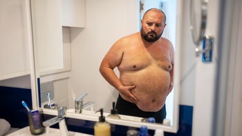 mens health: shirtless man looking at reflection 1787903122