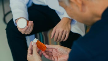 SSRIs: cropped doctor patient discussing two pill bottles 1397290480