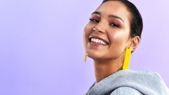 portrait woman with short hair purple gradient background yellow earrings 1295760261