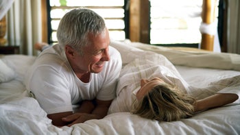 cialis: senior couple smiling in bed 200387803-001