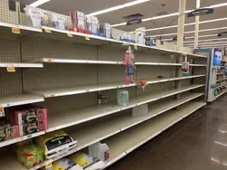 Empty shelves as supplies run low at a local Houston grocery store.
