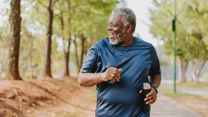 A man runs in a public park. 