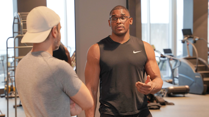 Jordan Morgan is pictured talking to a client in the gym.