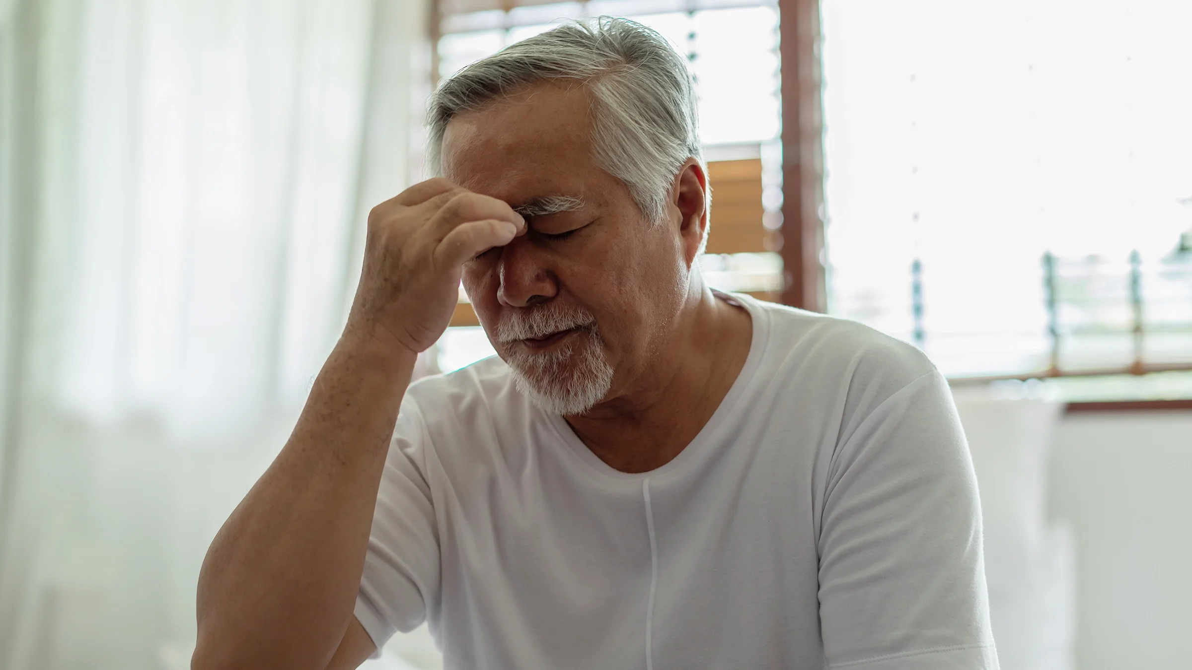 Older man with a migraine