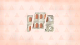 In the center of a light orange background with warning sign pattern and texture is a blister pack of oblong orange pills cut into thirds. 
GoodRx Health