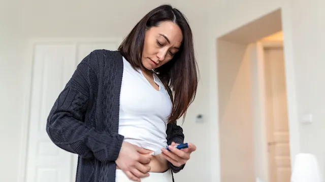 Health: Trulicity: woman injecting stomach 1388575782