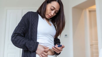 Health: Trulicity: woman injecting stomach 1388575782