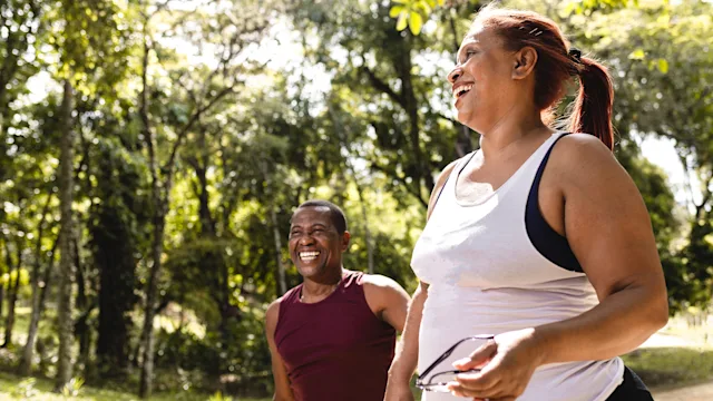 Musculoskeletal: man and woman walking in park 1059833160