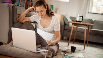 Health: Medical debt: woman working on laptop 523154430