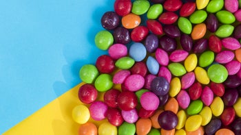 Diet nutrition: skittles candy on bright background 1450259259