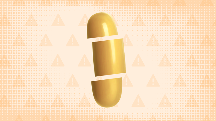 Light-orange background with texture and warning sign pattern. In the center is a yellow-orange gel pill cut into thirds. 