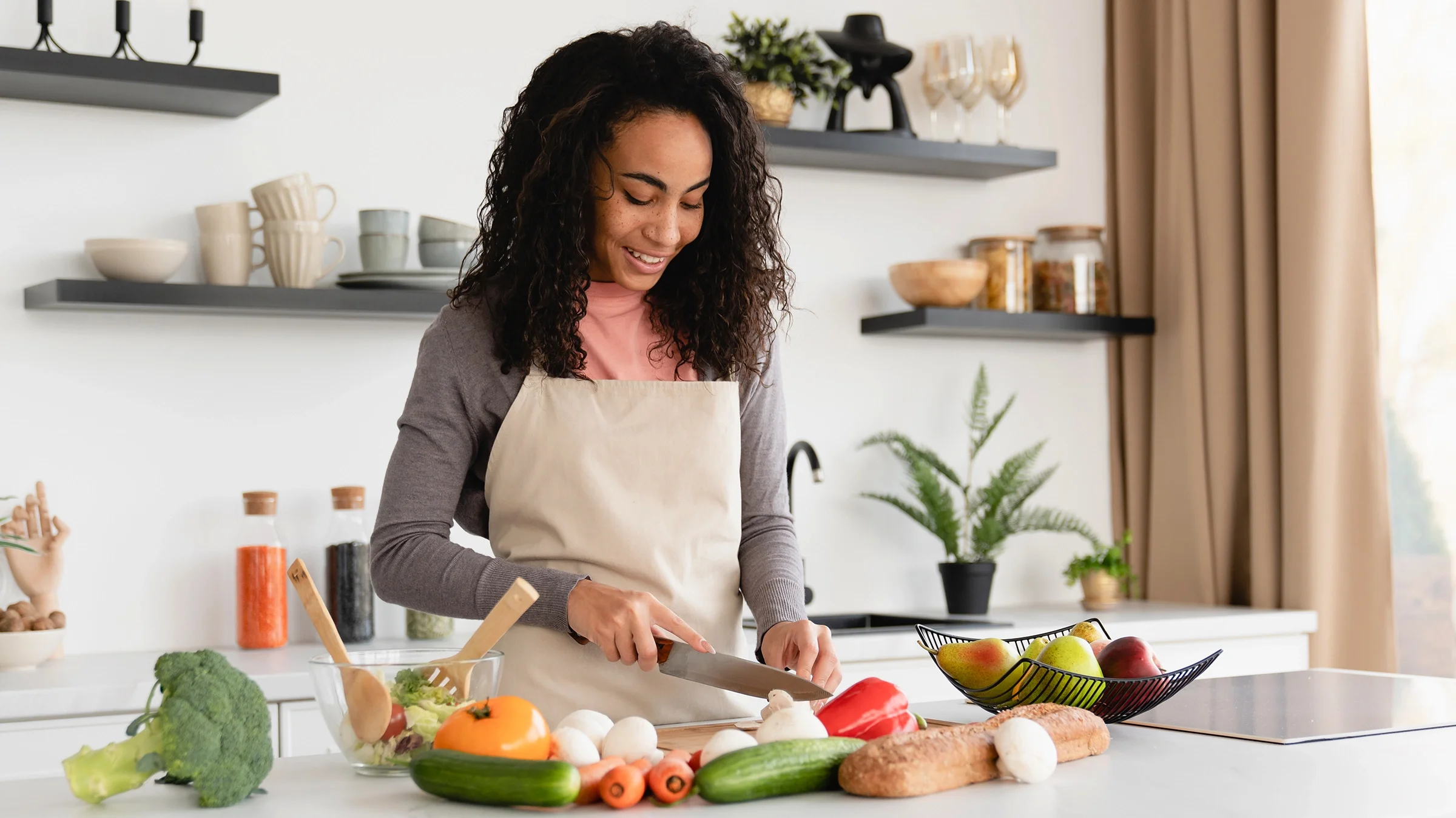 A woman with PCOS is prepping a healthy meal at home.