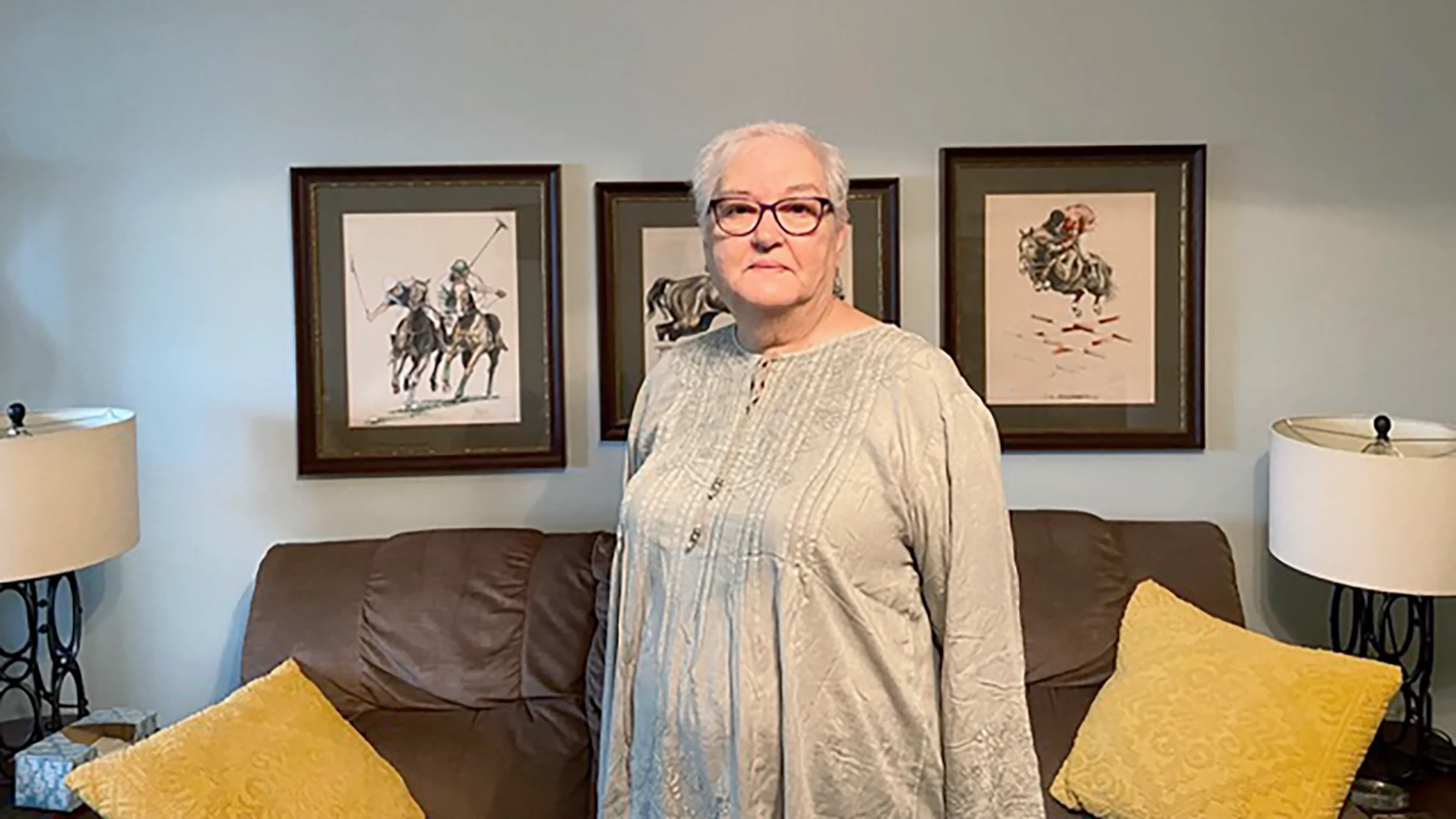 Portrait of Cynthia Zimmerman, standing in her living room.