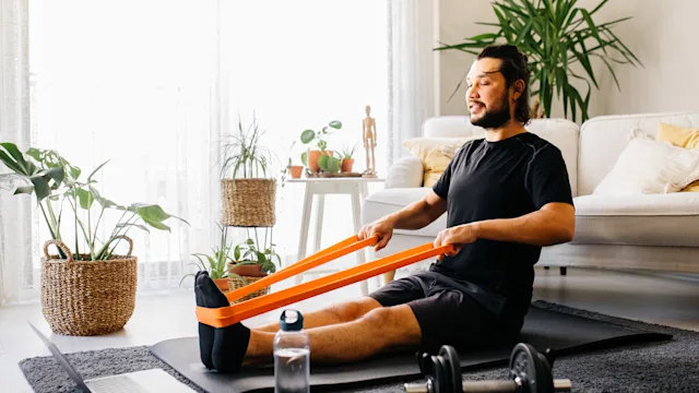 Musculoskeletal: Upper cross syndrome exercises: man doing resistance band row exercise 1294175391