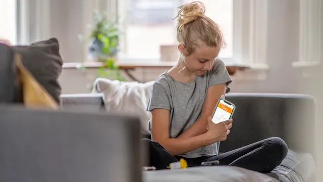 Medical supplies and devices: FreeStyle Libre: young kid checking insulin levels 1324060211