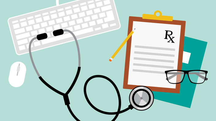 Teclado com estetoscópio e almofadas de prescrição e óculos