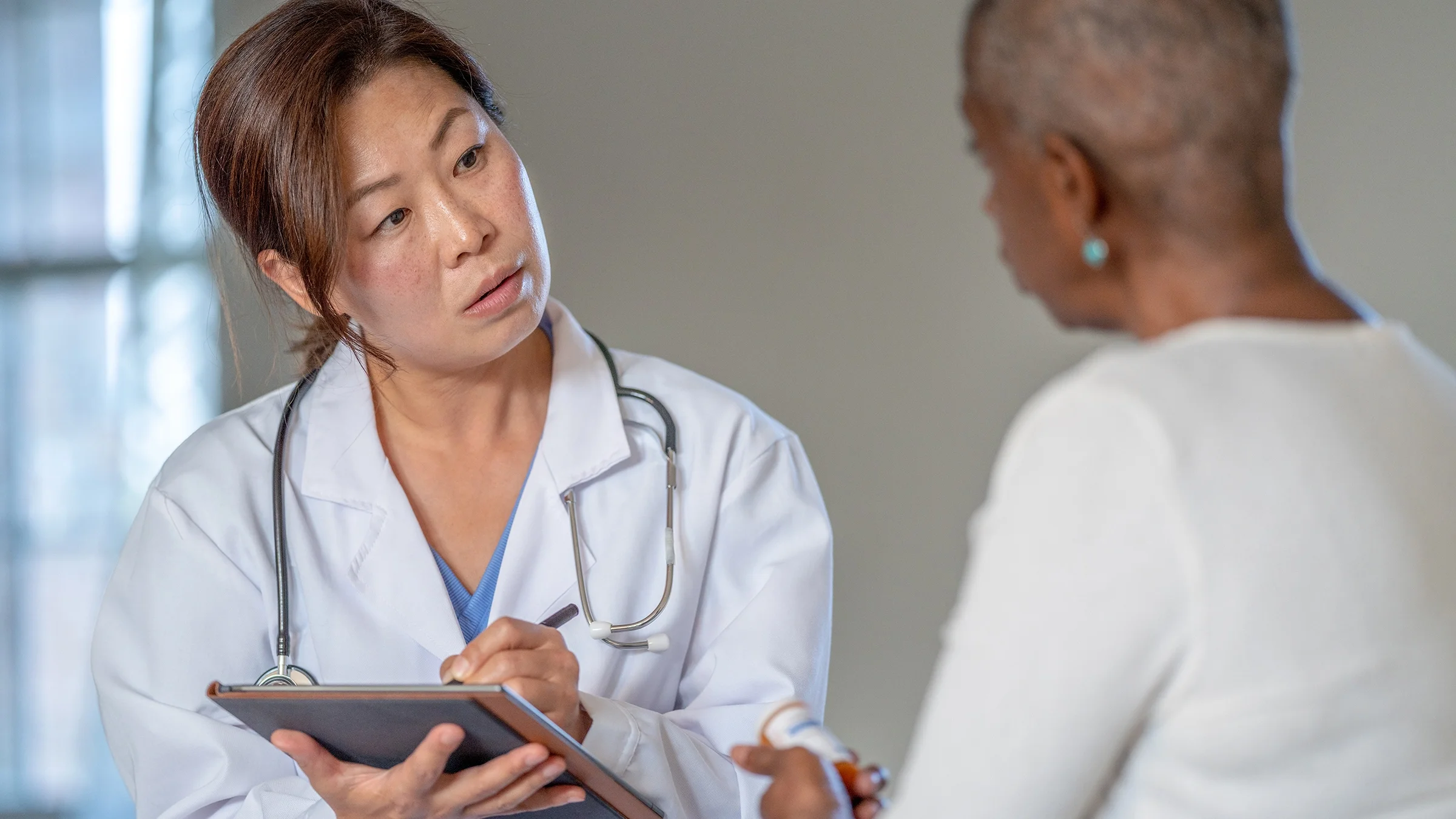A healthcare professional speaks with a patient.