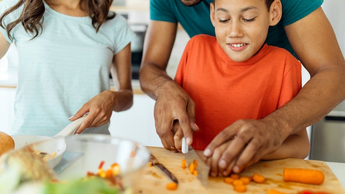 Family cooking dinner together at home.
