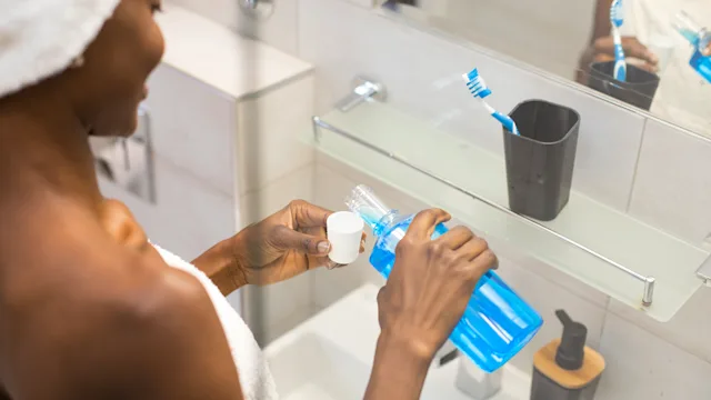 Dental-care: closeup pouring mouthwash 924375740