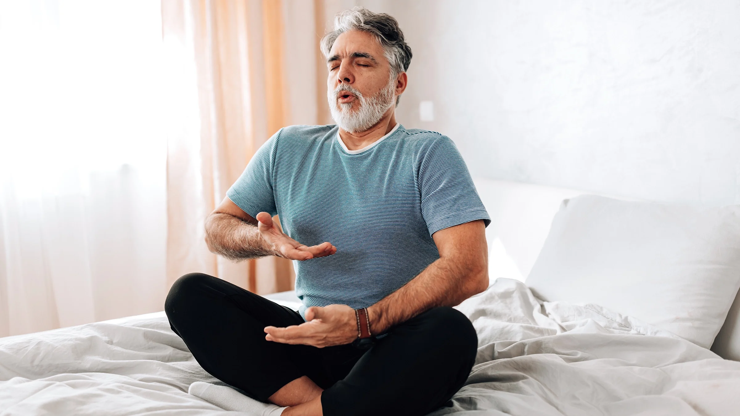Man doing breathing exercise at home