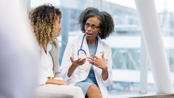 Medicaid: medical professional speaking to a patient 1132124013
