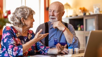 Atorvastatin: Interactions: senior couple reviewing medications looking up online-1313878535