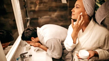 Dermatology: couple doing morning skin regimens-1223031984