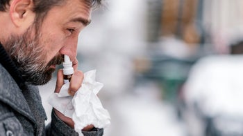 Health: Allergies: man using nasal spray 1124764912