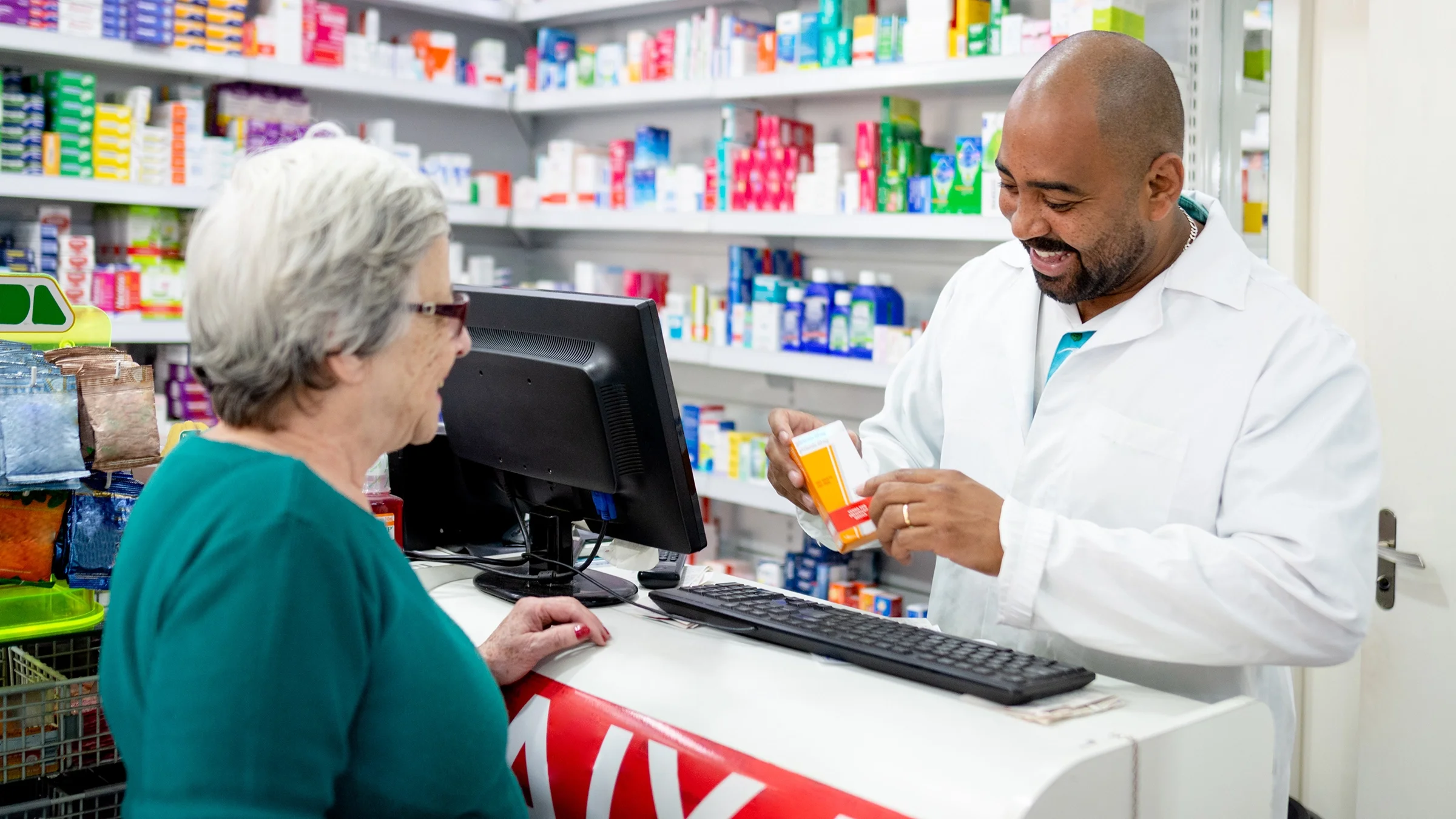 A pharmacist helps a customer.