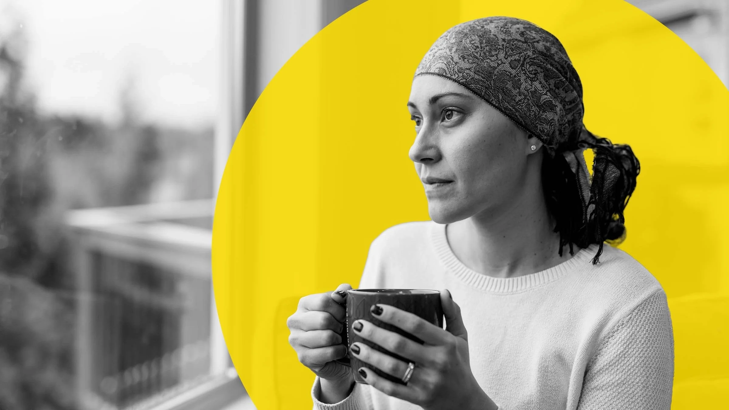 Black and white portrait of a woman with cancer wearing a headscarf. She is looking out the window while drinking a cup of coffee. There is also an added yellow graphic circled behind her head.