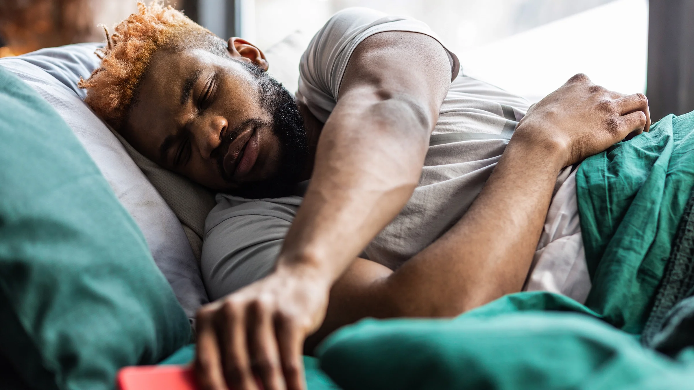 Man feeling groggy while waking up in the morning.