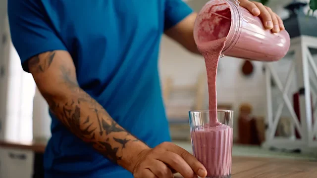 Diet-nutrition: closeup pouring a smoothie 2223786147