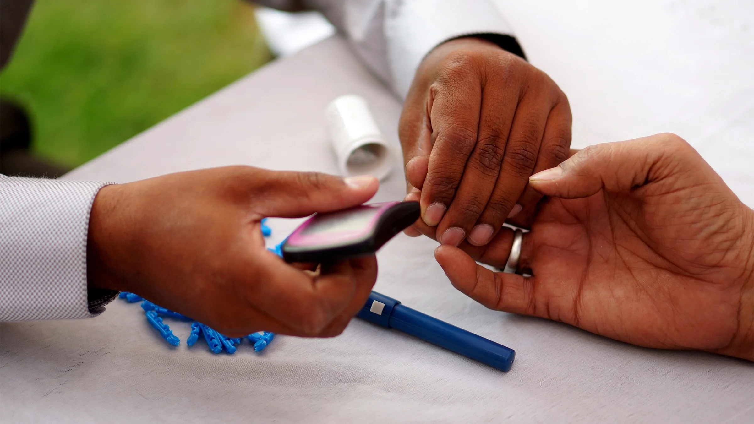 Doctor conducts a blood test on a patient.