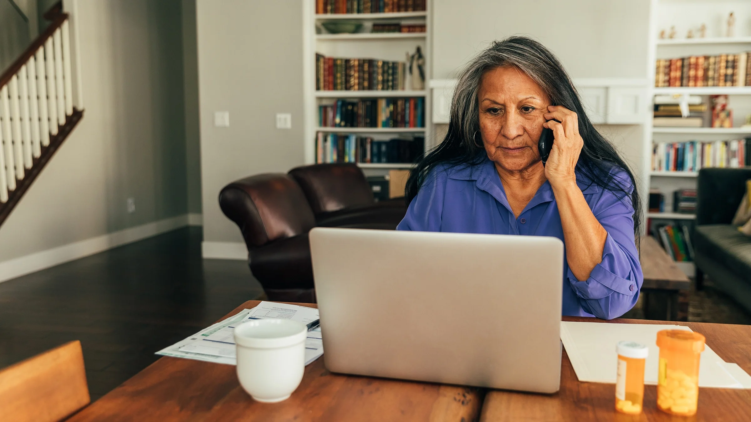 A senior woman participates in a telemedicine visit.