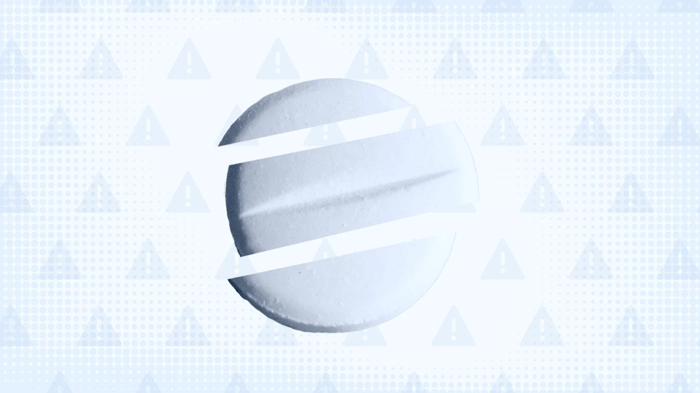 Light blue background with a halftone and warning sign patterns. In the center is a blue tinted round pill cut into thirds. 
GoodRx Health