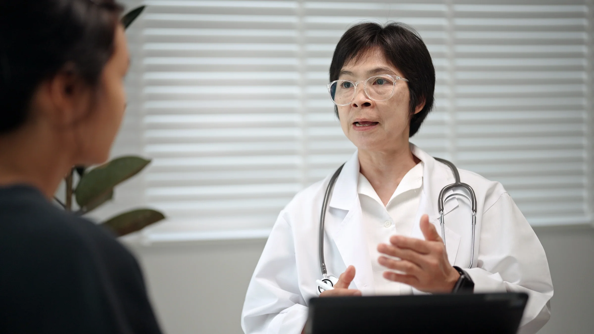 A medical professional has a consultation with a patient.