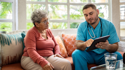 A medical professional uses a digital tablet while talking to a senior woman.
FG Trade Latin/E+ via Getty Images