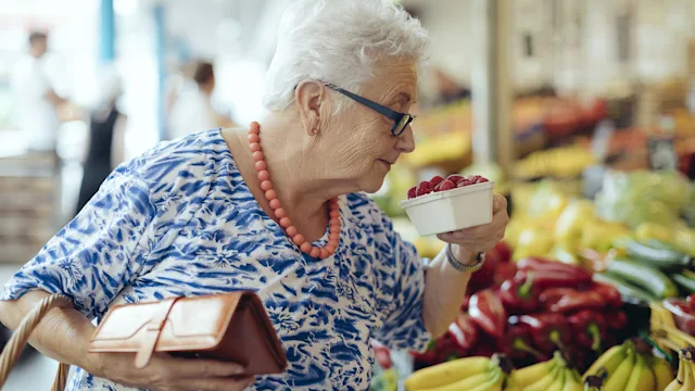 Diet Nutrition: Fruit: senior woman buying rasberries 1363106493