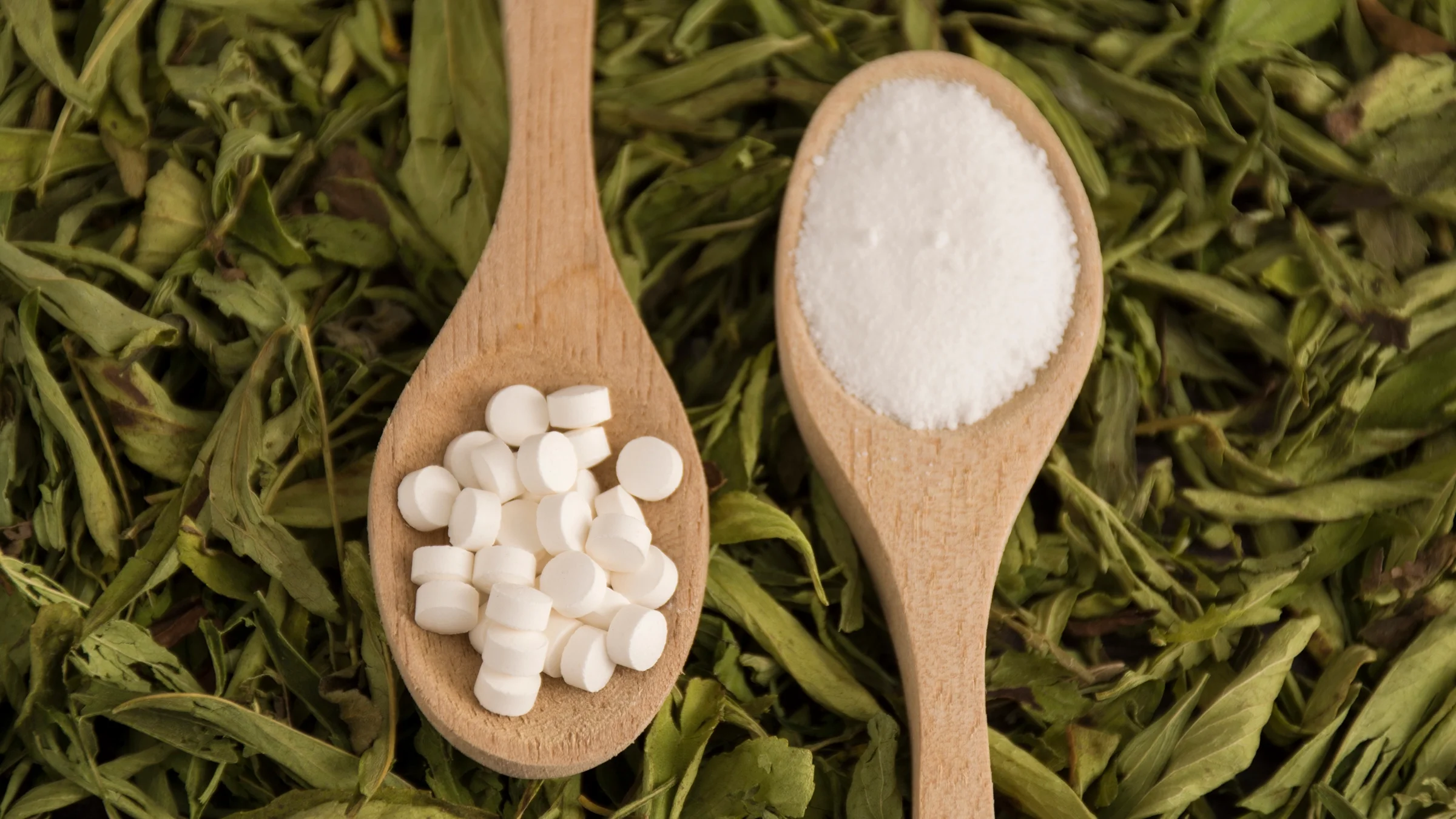 Spoonfuls of stevia sweetener lie on top of a bed of stevia leaves. Stevia is a sugar substitute recommended for people with diabetes, but some stevia products can raise blood glucose levels.