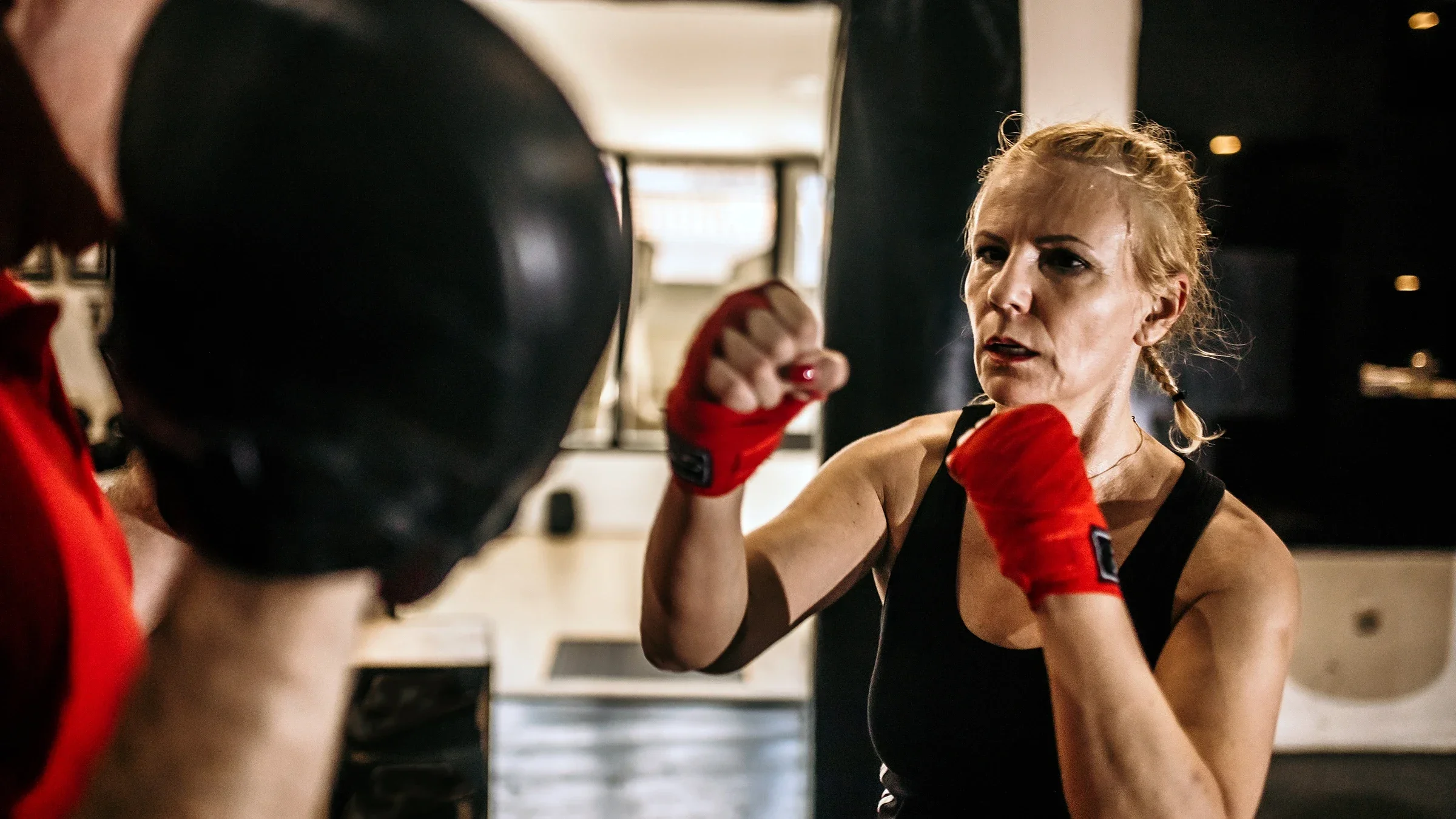 A woman is training with a boxer.
anandaBGD/E+ via Getty Images