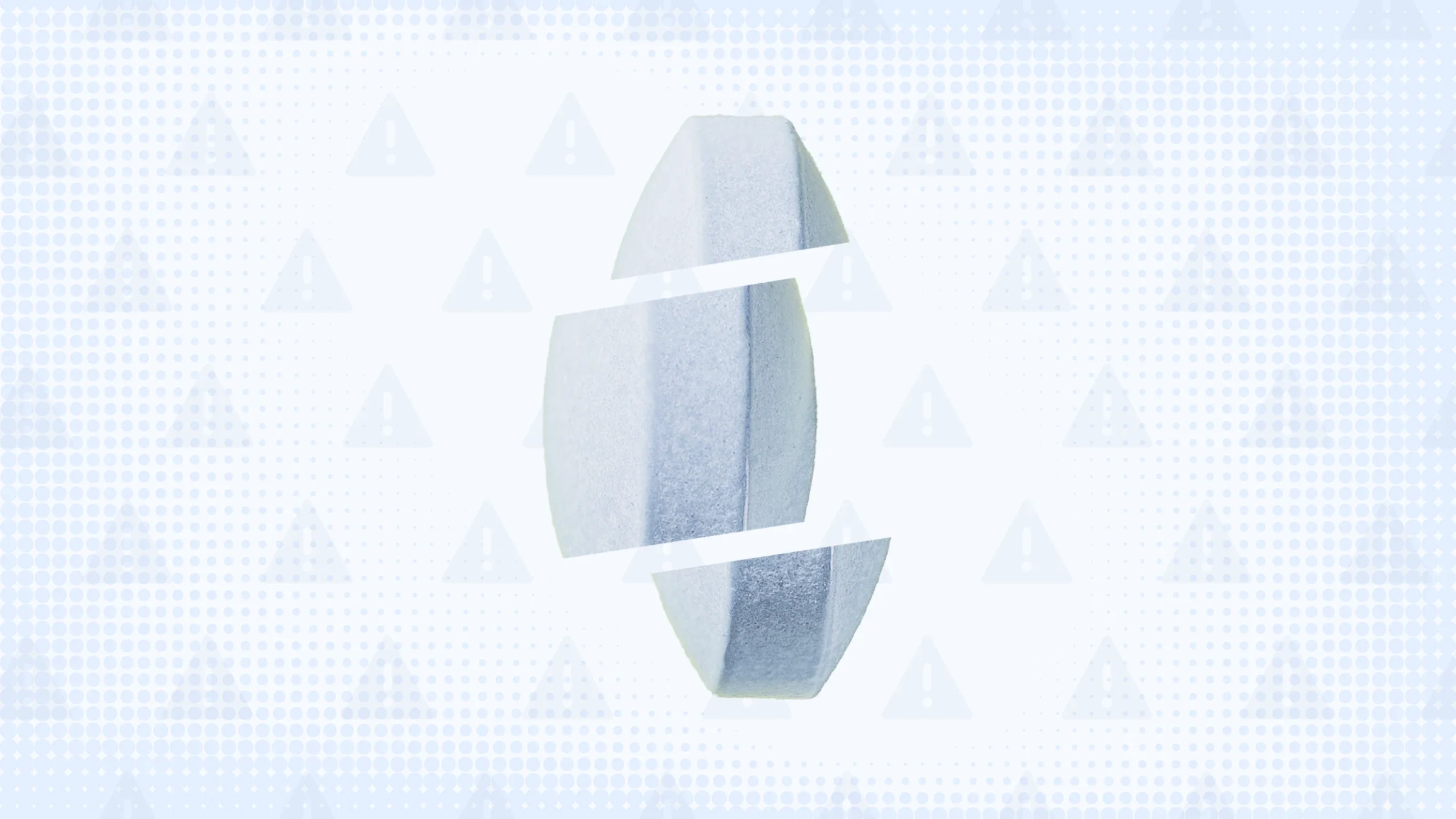 Light blue background with texture and warning sign pattern. In the center is a blue-ish pill standing up on its edge cut into thirds. 
GoodRx Health
