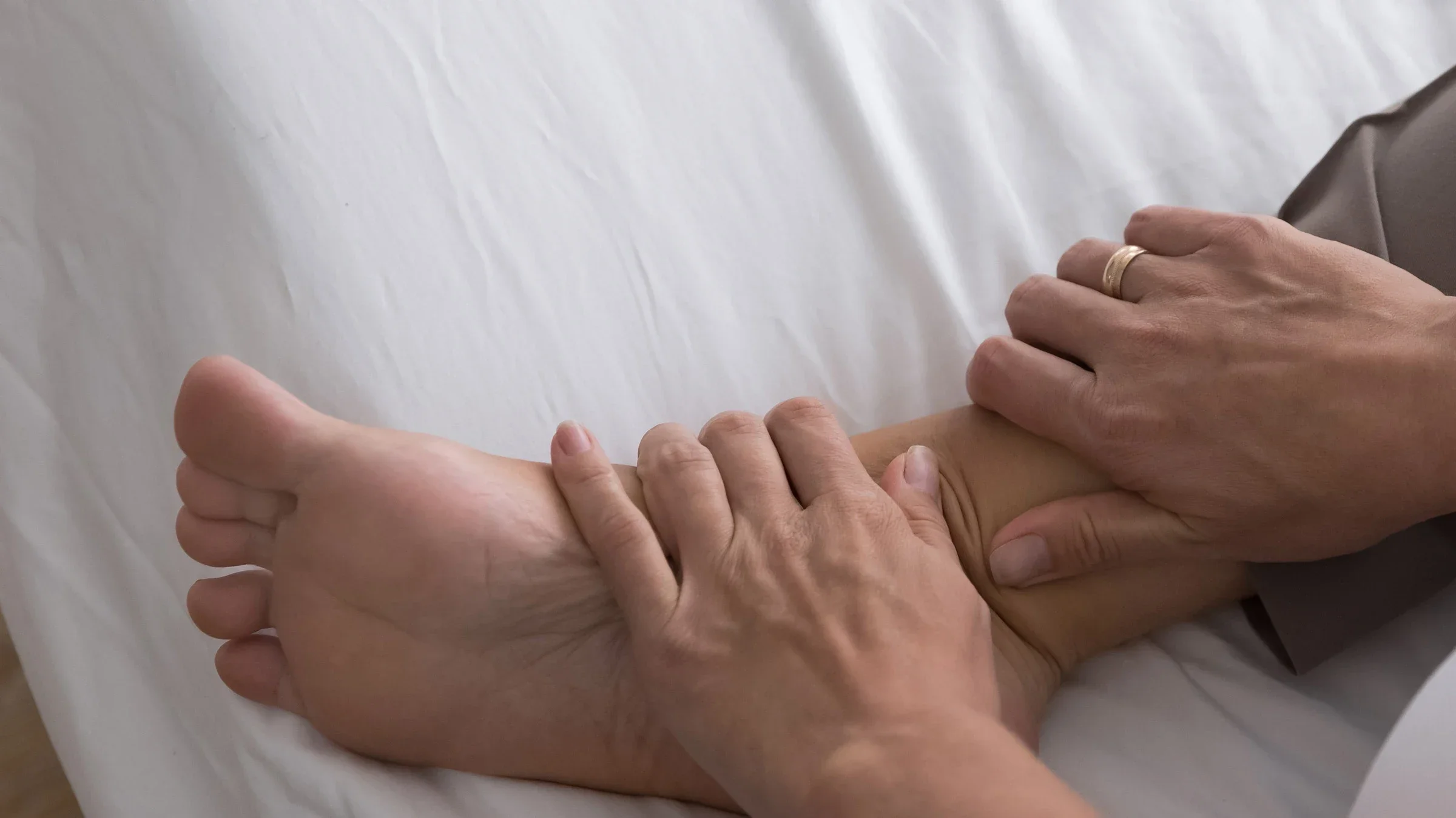 Cropped shot of a person massaging swollen ankles. 
fizkes/iStock via Getty Images Plus 