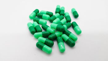 Cephalexin: green capsule pill pile-915486772