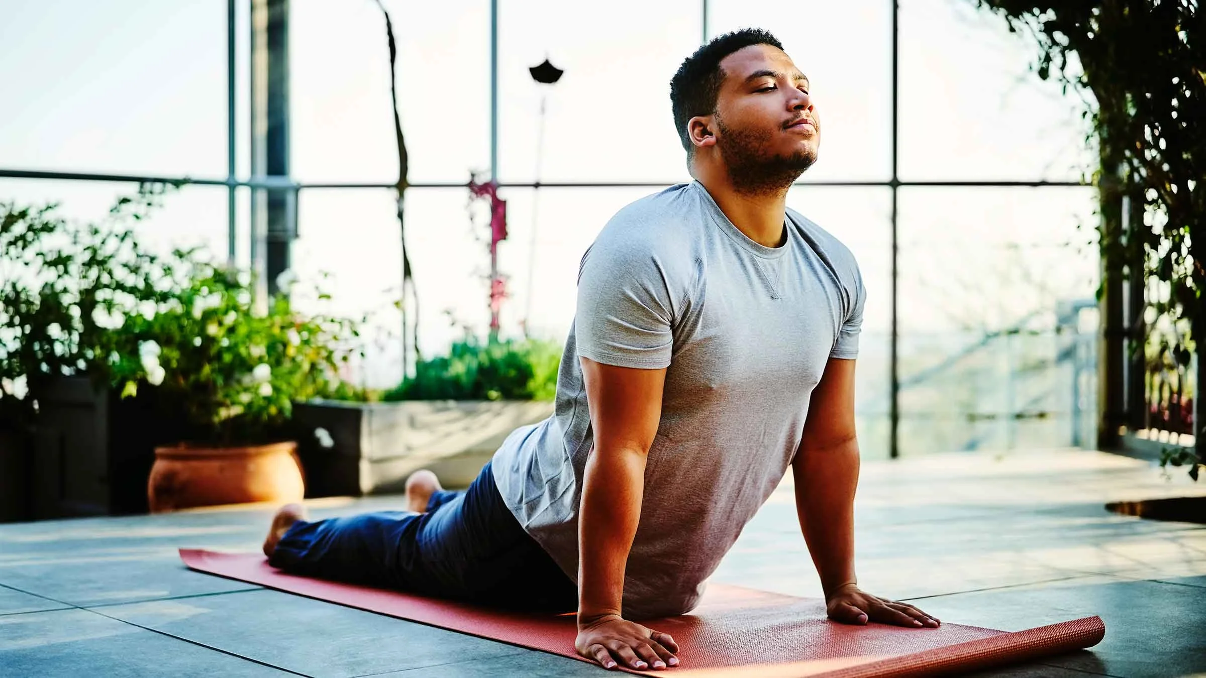 A man practices the Upward-Facing Dog pose.