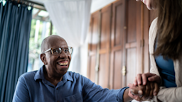 A man smiles and laughs with his home caregiver.
FG Trade/E+ via Getty Images 
