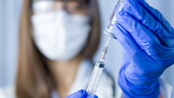 Hep C: scientist holding vaccine 1302343823