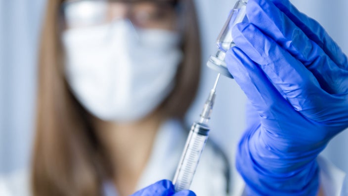 A scientist holding a vaccine.