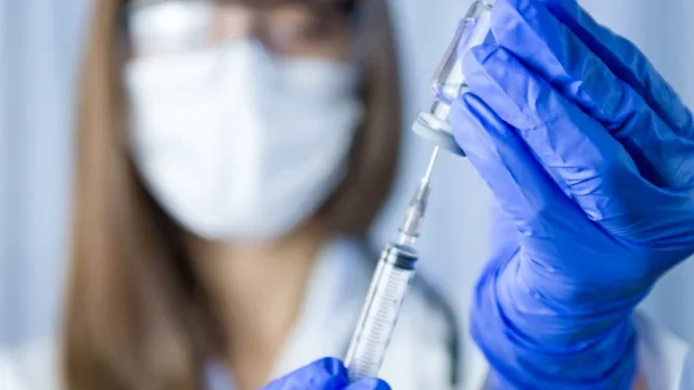 Hep C: scientist holding vaccine 1302343823
